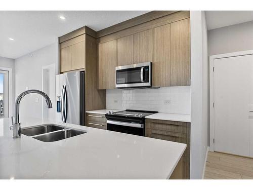 3403-111 Wolf Creek Drive Se, Calgary, AB - Indoor Photo Showing Kitchen With Double Sink With Upgraded Kitchen