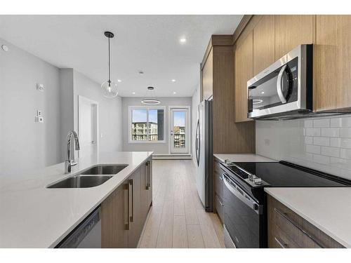 3403-111 Wolf Creek Drive Se, Calgary, AB - Indoor Photo Showing Kitchen With Double Sink With Upgraded Kitchen