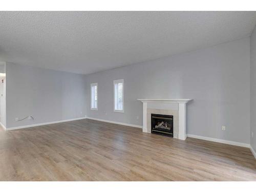 103-44 6A Street Ne, Calgary, AB - Indoor Photo Showing Living Room With Fireplace