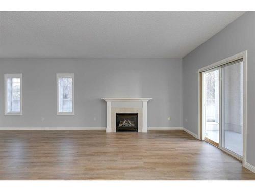 103-44 6A Street Ne, Calgary, AB - Indoor Photo Showing Living Room With Fireplace