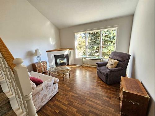 Unit #1-26 Quigley Drive, Cochrane, AB - Indoor Photo Showing Living Room With Fireplace