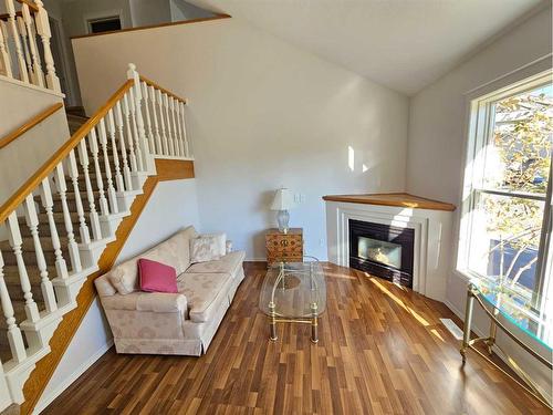 Unit #1-26 Quigley Drive, Cochrane, AB - Indoor With Fireplace