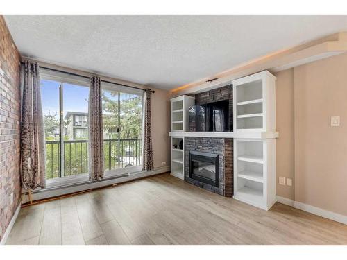 8-2902 17 Avenue Sw, Calgary, AB - Indoor Photo Showing Living Room With Fireplace