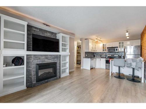 8-2902 17 Avenue Sw, Calgary, AB - Indoor Photo Showing Living Room With Fireplace