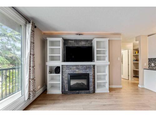 8-2902 17 Avenue Sw, Calgary, AB - Indoor Photo Showing Living Room With Fireplace