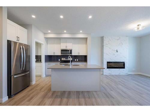 231 Cornerbrook Road Ne, Calgary, AB - Indoor Photo Showing Kitchen With Fireplace