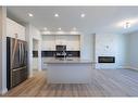 231 Cornerbrook Road Ne, Calgary, AB  - Indoor Photo Showing Kitchen With Fireplace 