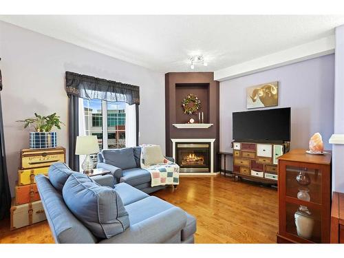 427-8535 Bonaventure Drive Se, Calgary, AB - Indoor Photo Showing Living Room With Fireplace