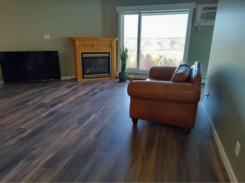 331-100 2 Avenue South, Lethbridge, AB - Indoor Photo Showing Living Room With Fireplace