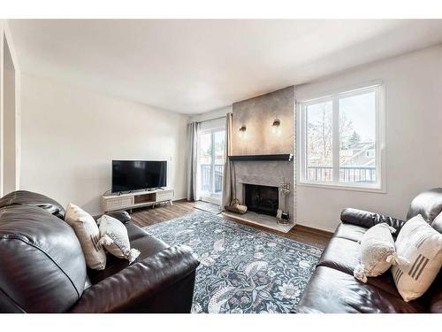 203 37 Street Nw, Calgary, AB - Indoor Photo Showing Living Room With Fireplace