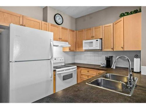 204-107 Montane Road, Canmore, AB - Indoor Photo Showing Kitchen With Double Sink