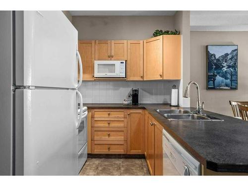 204-107 Montane Road, Canmore, AB - Indoor Photo Showing Kitchen With Double Sink