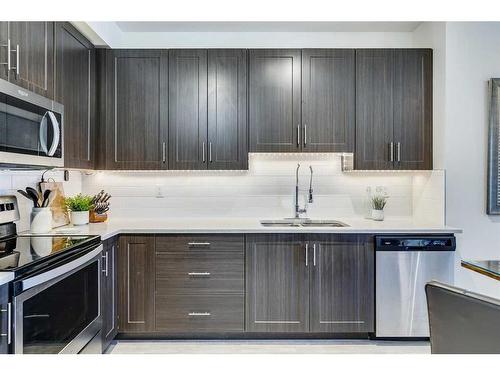 7403-151 Legacy Main Street Se, Calgary, AB - Indoor Photo Showing Kitchen With Stainless Steel Kitchen With Double Sink