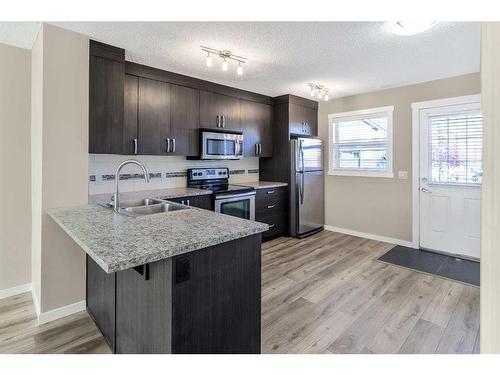 74 Auburn Bay Link Se, Calgary, AB - Indoor Photo Showing Kitchen With Double Sink