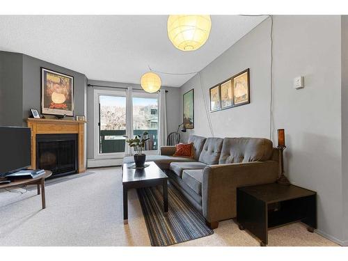 8205-315 Southampton Drive Sw, Calgary, AB - Indoor Photo Showing Living Room With Fireplace