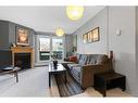 8205-315 Southampton Drive Sw, Calgary, AB  - Indoor Photo Showing Living Room With Fireplace 