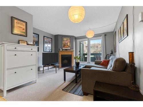 8205-315 Southampton Drive Sw, Calgary, AB - Indoor Photo Showing Living Room With Fireplace