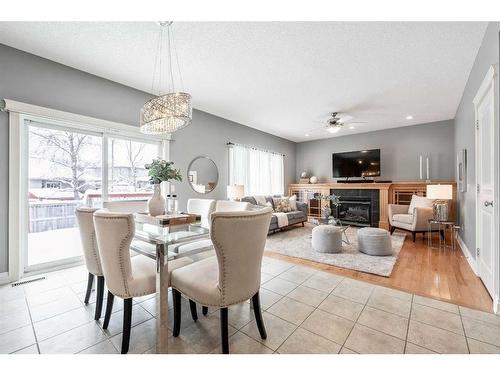 115 Railway Crescent Se, Langdon, AB - Indoor Photo Showing Dining Room With Fireplace