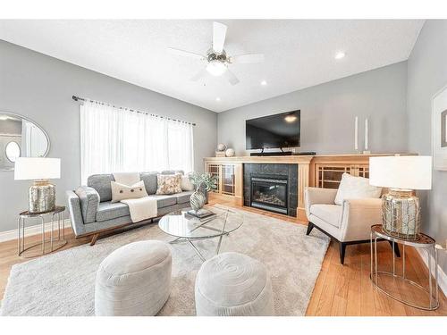 115 Railway Crescent Se, Langdon, AB - Indoor Photo Showing Living Room With Fireplace