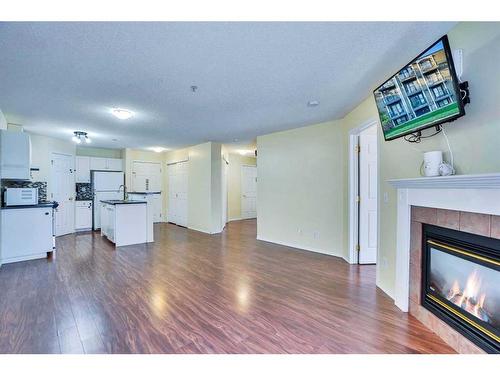 310-290 Shawville Way Se, Calgary, AB - Indoor Photo Showing Living Room With Fireplace