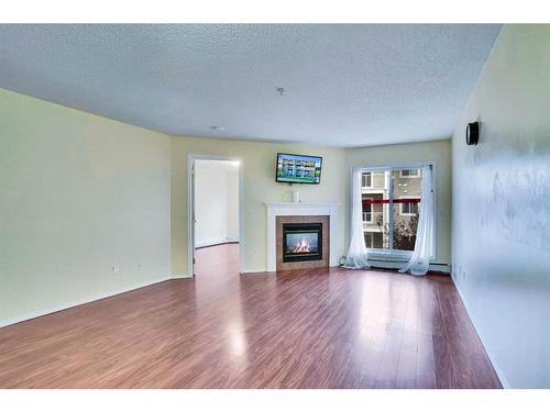 310-290 Shawville Way Se, Calgary, AB - Indoor Photo Showing Living Room With Fireplace