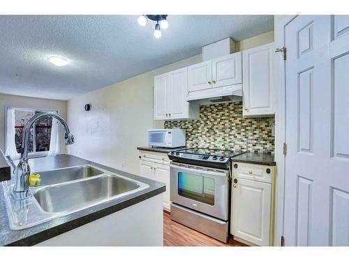 310-290 Shawville Way Se, Calgary, AB - Indoor Photo Showing Kitchen With Double Sink