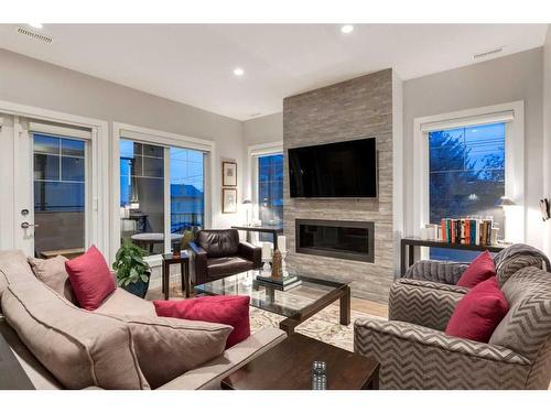 4-2432 30 Street Sw, Calgary, AB - Indoor Photo Showing Living Room With Fireplace