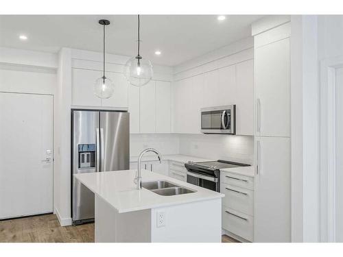 4307-111 Wolf Creek Drive Se, Calgary, AB - Indoor Photo Showing Kitchen With Double Sink With Upgraded Kitchen