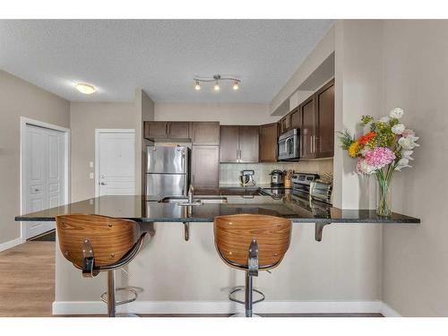 106-76 Panatella Road Nw, Calgary, AB - Indoor Photo Showing Kitchen With Double Sink