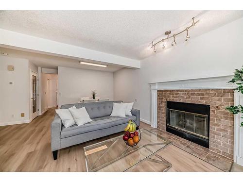 222 Cedarwood Park Sw, Calgary, AB - Indoor Photo Showing Living Room With Fireplace