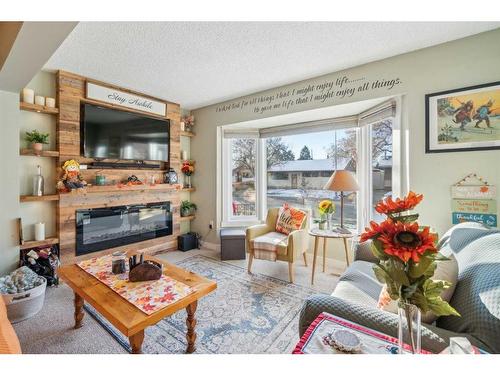 9116 Academy Drive Se, Calgary, AB - Indoor Photo Showing Living Room With Fireplace