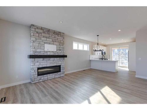 105 Cottageclub Drive, Rural Rocky View County, AB - Indoor Photo Showing Living Room With Fireplace