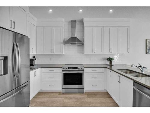 884 Seton Circle Se, Calgary, AB - Indoor Photo Showing Kitchen With Stainless Steel Kitchen With Double Sink With Upgraded Kitchen