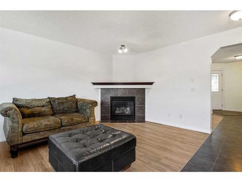 400 Kincora Drive Nw, Calgary, AB - Indoor Photo Showing Living Room With Fireplace