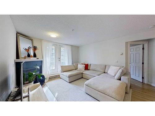 105-2212 34 Avenue Sw, Calgary, AB - Indoor Photo Showing Living Room With Fireplace