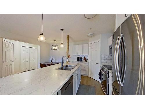 105-2212 34 Avenue Sw, Calgary, AB - Indoor Photo Showing Kitchen With Stainless Steel Kitchen With Double Sink