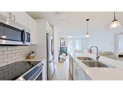 105-2212 34 Avenue Sw, Calgary, AB - Indoor Photo Showing Kitchen With Stainless Steel Kitchen With Double Sink With Upgraded Kitchen