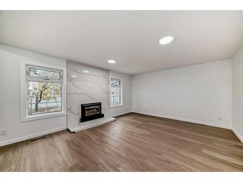 35 Mckinley Road Se, Calgary, AB - Indoor Photo Showing Living Room With Fireplace