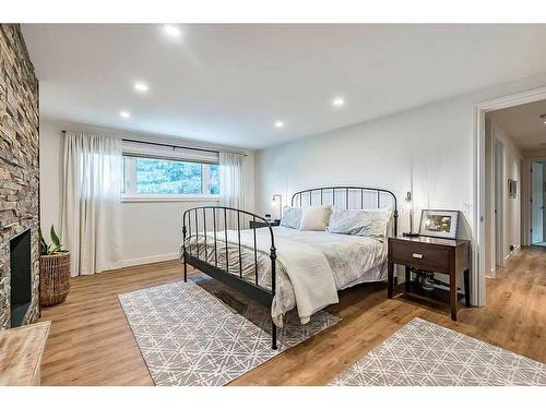 116 Canterbury Place Sw, Calgary, AB - Indoor Photo Showing Bedroom With Fireplace