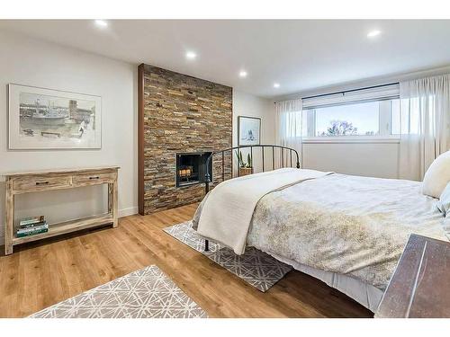 116 Canterbury Place Sw, Calgary, AB - Indoor Photo Showing Bedroom With Fireplace