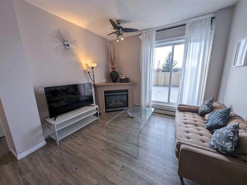 212-1507 Centre A Street Ne, Calgary, AB - Indoor Photo Showing Living Room With Fireplace