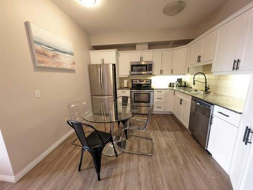 212-1507 Centre A Street Ne, Calgary, AB - Indoor Photo Showing Kitchen With Stainless Steel Kitchen With Double Sink