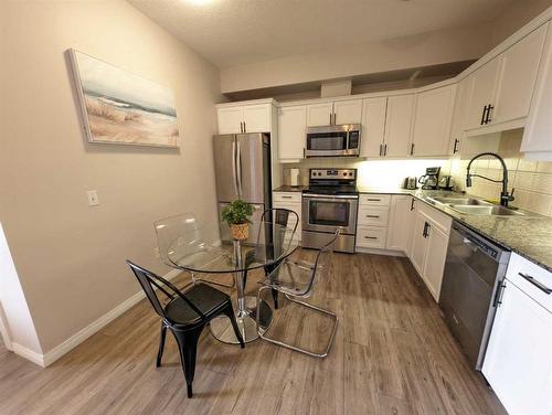 212-1507 Centre A Street Ne, Calgary, AB - Indoor Photo Showing Kitchen With Stainless Steel Kitchen With Double Sink