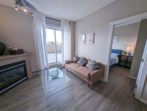 212-1507 Centre A Street Ne, Calgary, AB - Indoor Photo Showing Living Room With Fireplace