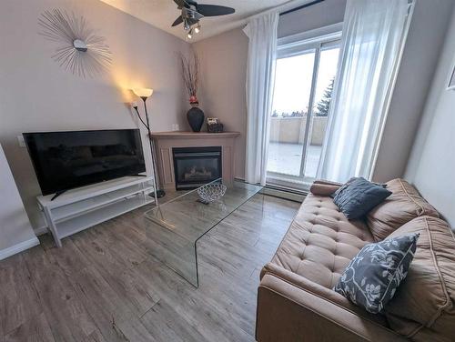 212-1507 Centre A Street Ne, Calgary, AB - Indoor Photo Showing Living Room With Fireplace