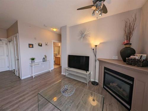 212-1507 Centre A Street Ne, Calgary, AB - Indoor Photo Showing Living Room With Fireplace