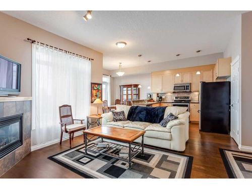 401-4 Hemlock Crescent Sw, Calgary, AB - Indoor Photo Showing Living Room With Fireplace