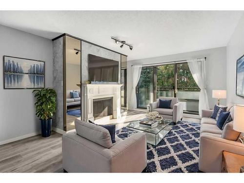 207-3730 50 Street Nw, Calgary, AB - Indoor Photo Showing Living Room With Fireplace