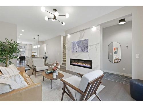 153 Burma Star Road Sw, Calgary, AB - Indoor Photo Showing Living Room With Fireplace