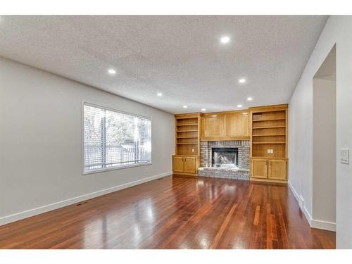 215 Hawkstone Close Nw, Calgary, AB - Indoor Photo Showing Living Room With Fireplace